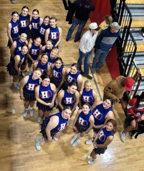 The varsity cheer team posing in a group photo at state. (Photo from Rudi Wilson) 

